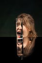 Scream. Modern art photography. Beautiful girl& x27;s face through glass of water. Object distortion, optical illusion Royalty Free Stock Photo