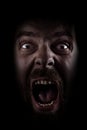 Scream of scared spooky man in dark Royalty Free Stock Photo