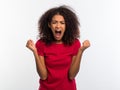 Screaming african american woman in red top with closed eyes. Depressed angry black girl over white background in studio