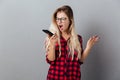 Screaming angry young blonde woman talking by phone. Royalty Free Stock Photo