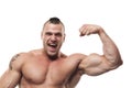 Screaming bodybuilder flexing arm. Shirtless excited muscular healthy young man flexing his biceps internal side. Royalty Free Stock Photo