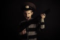 Screaming Boy with Police Hat Holding Rifle