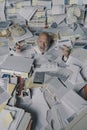 Screaming businessman drowning under a lot of paperwork Royalty Free Stock Photo