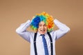 Screaming businessman with large colorful wig. Royalty Free Stock Photo