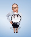 Screaming businesswoman with megaphone