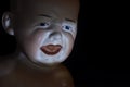 Screaming child doll head for halloween night Royalty Free Stock Photo