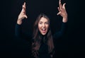 Screaming emotional angry woman with arms up isolated on black background Royalty Free Stock Photo