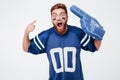 Screaming excited man fan in blue t-shirt standing isolated Royalty Free Stock Photo