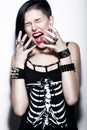 Screaming Girl with shaved head and blue hair in art gothic style with gothic accessories. Royalty Free Stock Photo