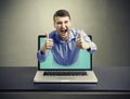 Screaming happy man got out of the laptop Royalty Free Stock Photo