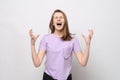 Angry teenage girl screaming with aggressive expression and arms raised. Frustration concept Royalty Free Stock Photo