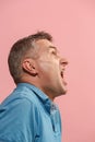 The young emotional angry man screaming on pink studio background Royalty Free Stock Photo