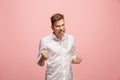 The young emotional angry man screaming on pink studio background Royalty Free Stock Photo