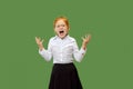 The young emotional angry teen girl screaming on green studio background Royalty Free Stock Photo