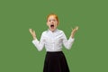 The young emotional angry teen girl screaming on green studio background Royalty Free Stock Photo