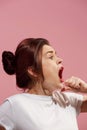 The young emotional angry woman screaming on pink studio background Royalty Free Stock Photo