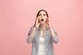 The young emotional angry woman screaming on pink studio background Royalty Free Stock Photo