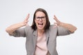 Screaming, hate, rage. Crying emotional angry woman screaming on white studio background