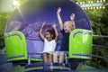Screaming Kids enjoying a fun summer amusement park ride Royalty Free Stock Photo
