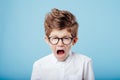 Screaming little boy in glasses look at the camera, Royalty Free Stock Photo
