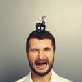 Screaming man with small bored man Royalty Free Stock Photo