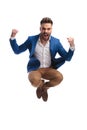 Screaming man in suit jumps with fists in the air Royalty Free Stock Photo