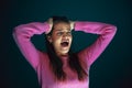 Close up portrait of young crazy scared and shocked woman isolated on dark background Royalty Free Stock Photo