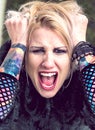 Screaming punk style woman with piercings and tattoos Royalty Free Stock Photo