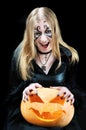 Screaming vampire girl with a halloween pumpkin Royalty Free Stock Photo