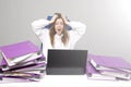 Screaming woman at desk with laptop and folders. Female entrepreneur suffers from nervous breakdown caused by fatigue, too much