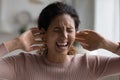 Screaming woman plug up with fingers ears annoyed by noise Royalty Free Stock Photo
