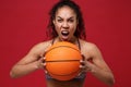 Screaming young african american sports fitness basketball player woman in sportswear working out isolated on red Royalty Free Stock Photo