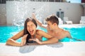 Screaming young teenage girl at the pool annoyed with pool splashing.Splashing water and playing games at the pool,having fun Royalty Free Stock Photo