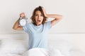 Screaming young woman holding alarm clock Royalty Free Stock Photo