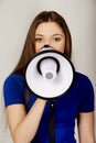 Screaming young woman with megaphone. Royalty Free Stock Photo