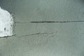 Screed Failure. Cement screed cracked. Gray stone background. Problems can involve cracking, breaking up of the screed , indentati Royalty Free Stock Photo