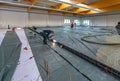 Screed is poured on a construction site inside a large factory building