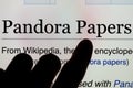 Screen with finger pointing at Wikipedia search Pandora papers.