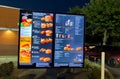 Screen showing menu at the entrance of a local Mc Donalds restaurant