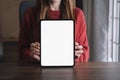 Screen tablet mockup for advertising text, Female hand using tablet texting contact business search information on desk in Royalty Free Stock Photo