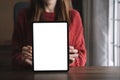 Screen tablet mockup for advertising text, Female hand using tablet texting contact business search information on desk in Royalty Free Stock Photo