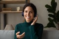 Portrait of young Latin woman in headphones talk on webcam Royalty Free Stock Photo