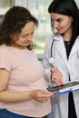 Pregnant woman and female doctor consulting about the ultrasound scan of baby. Obstetrics and gynecology. Pregnancy Royalty Free Stock Photo