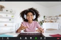 Screenshot of cheerful african american school girl having online class Royalty Free Stock Photo