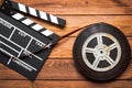 Screenwriter desktop with movie clapper board wooden background top view Royalty Free Stock Photo