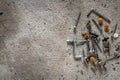 Screw, nail on concrete texture background. Closeup of screws and nails on cement floor, copy space Royalty Free Stock Photo