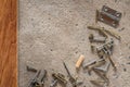 Screw, nail on concrete wood texture background. Closeup of screws and nails on cement and wooden floor, copy space Royalty Free Stock Photo