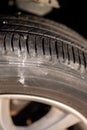 screw protruding from the tread of a tire causing a flat. Royalty Free Stock Photo