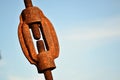 A thread - rusty, aged and dirty metallic part with clear sky in the background.