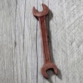 Screw wrench made of chocolate lying on grey wood. Royalty Free Stock Photo